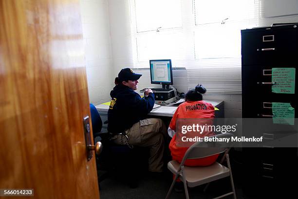Probation officer helps a new arrival at Camp Kenyon Scudder fill out intake paperwork after arriving to serve her time at the girls detention...