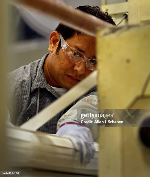 Romeo Sandoval inspects the weaving process on the Hydranautics spiralwound reverse osmosis membrane at the company's Oceanside business.The...