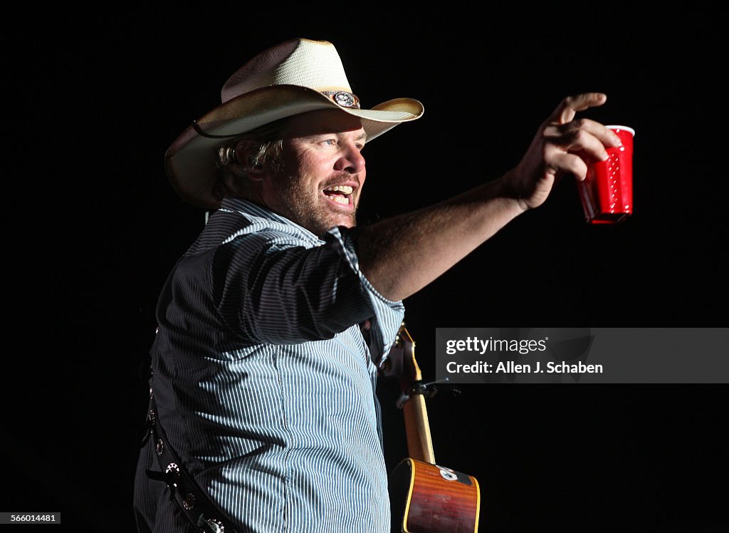 Toby Keith toasts his fans with a red solo cup, the name of one of his hit songs on the Mane Stage