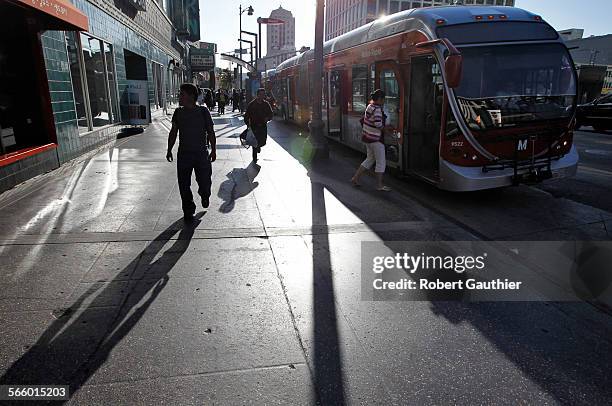 Riders board a Metro Rapid bus at the stop at Wilshire and Western. The City of LA is proposing a dedicated bus lane to cut travel times between...