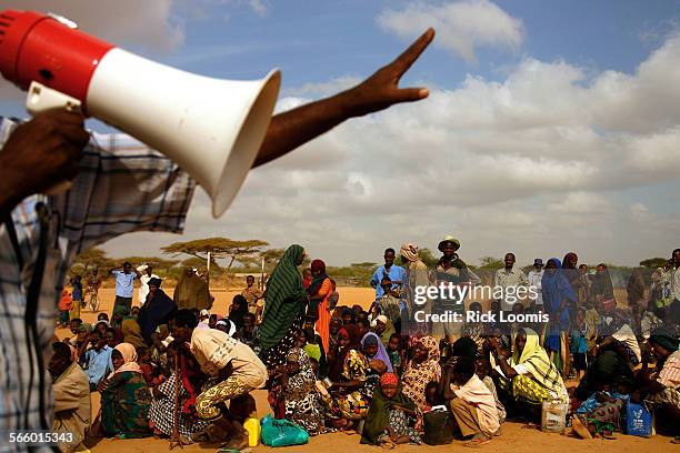 Newly arriving refugees, mostly Somalis, crowd into a line to be admitted into Dadaab, the largest refugee camp in the world. At times, more than...