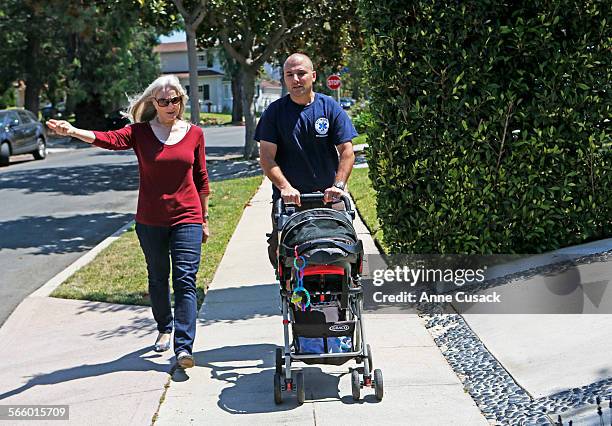 Colleen Mason and Greg Spiegelman with his baby Drew walk the streets of their neighborhood in Cheviot Hills in Los Angeles on July 24, 2013. They...