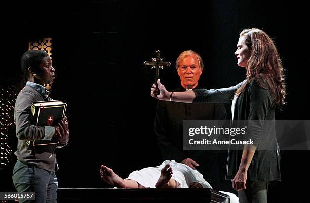 Brooke Shields as Chris MacNeil, right confronts Roslyn Ruff as Carla, left, about the crucifix Carla had given her daughter Emily Yetter as Regan...