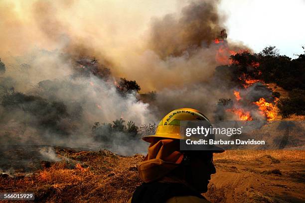 Firefighter look over a raging fire on a Monrovia near homes April 20, 2013. Firefighting airplanes were called in to protect homes on the...