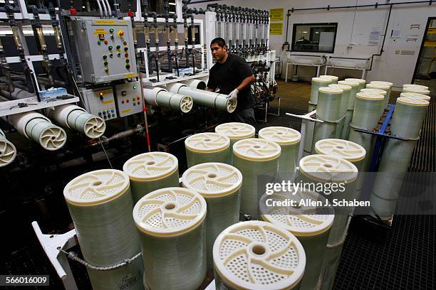 Jorge Estrada performs a saltwater test on the Hydranautics spiral-wound reverse osmosis membrane at the company's Oceanside business.The...