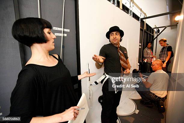 Rodion Pogossov, right, as the character Papageno with Director Suzanne Andrade, left, behind the projection wall during rehearsals for Mozarts "The...