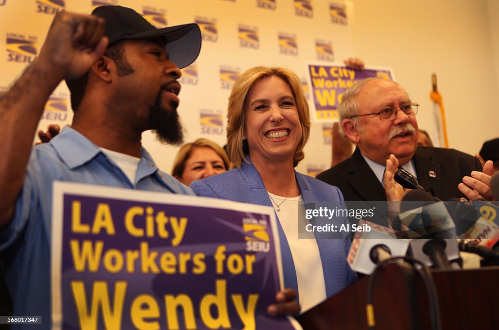 Los Angeles city controller and mayoral candidate Wendy Greuel, center, smiles as Bob Schoonover, r