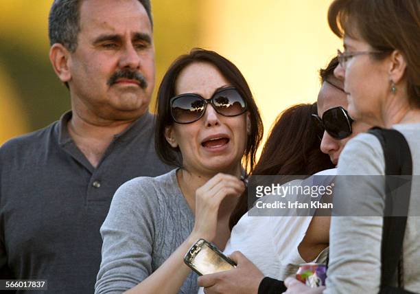 February 11 , 2010 ; Grieving people huddle near a home where a woman was fatally shot inside a residence in Whittier. Whittier police SWAT...