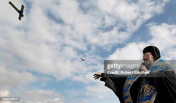 His Eminence Metropolitan Gerasimos, who oversees the Greek Orthodox Metropolis of San Francisco, slings a cross into the water at Mother's Beach,...