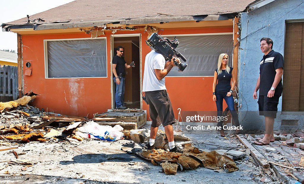 TV hosts Tarek El Moussa , right, and his wife Christina El Moussa, second from right,  talk during