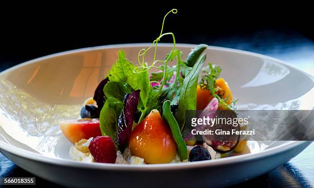 Colorful dish of beets and sliced berries decorated with a forest's worth of fronds and leaves by Chef C.J. Jacobson at Girasol restaurant on October...