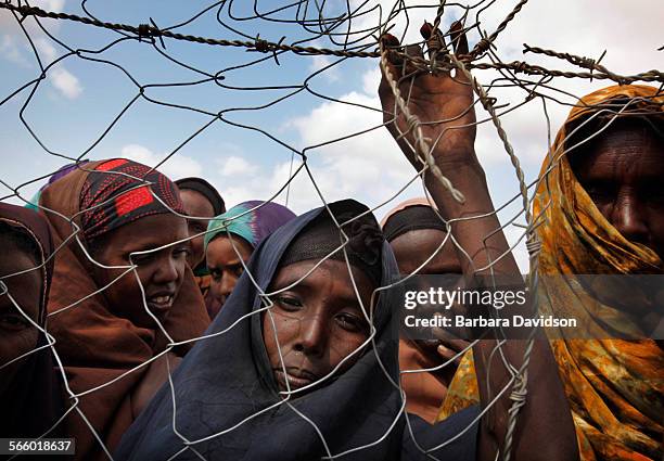 Somali refugees, known as "new arrivals" wait to be registered at Camp IFO, on the outskirts of Dadaab. Depending on which aid agency you ask 000 to...