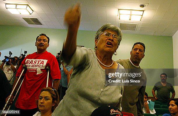 Bell residents Sergio Varga, left, Carmen Bella and Willie Aguilar stand and denounce members of the Bell City Council following a council meeting at...