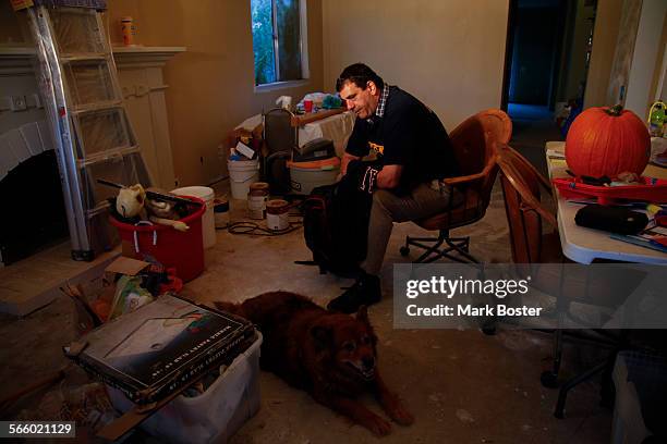 Single father Tim Maimone sits on a chair in his livingroom in his Mission Viejo home that is under renovation. Maimone is a Dept of Defense worker...