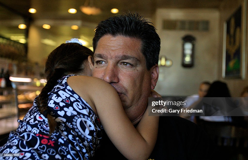 Rescue 5 firefighter Joey Esposito holds his daughter, Jolie, in a Staten Island diner on July 5, 2