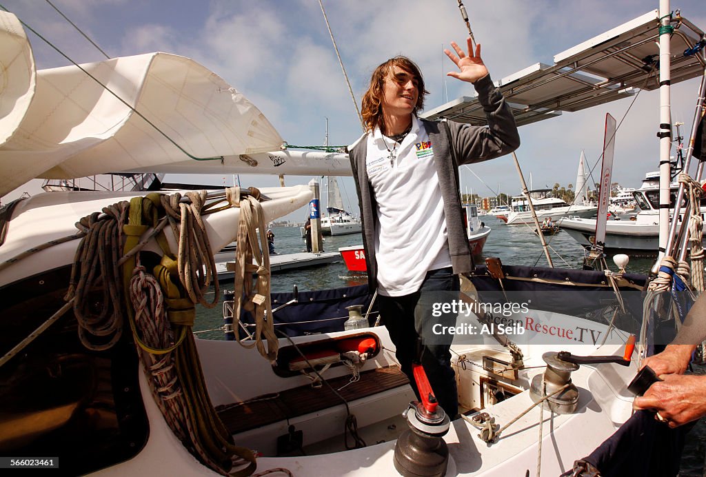 Global sailor Zac Sunderland waves to cheering crowds as he pulls into Marina Del Rey's Fisherman's