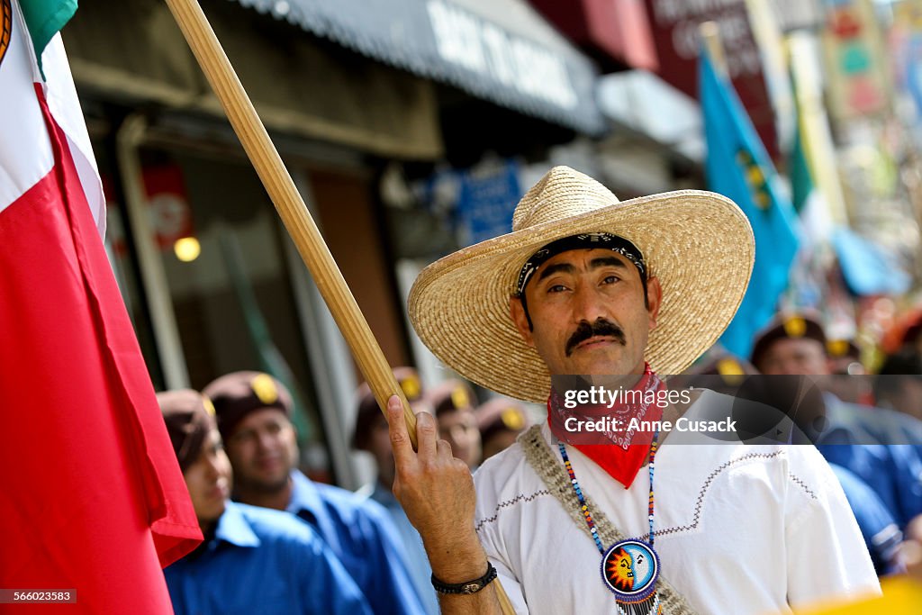 Humberto Renterria (CQ) carries a flag as a march is held on Whittier Boulevard in East Los Angeles