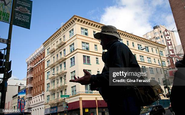 Silhouetted against historical buildings, Mark Ellinger photographs some of his favorite architecture in the "Tenderloin" district of San Francisco...