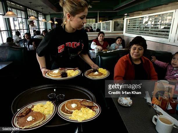 Gaby Estrella , serves Grand Slam breakfast at Denny's Restaurant in Santa Ana on the morning of February 03, 2009. Competition among casual...