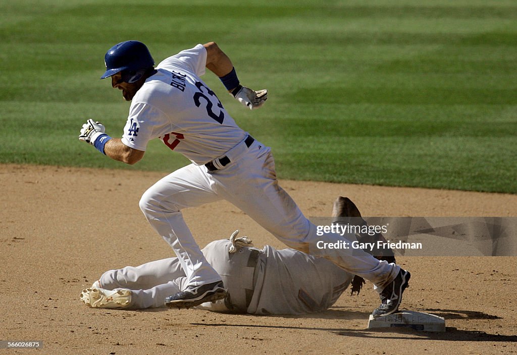 Casey Blake of the Los Angeles Dodgers runs past shortstop Jose Reyes of the N.Y. Mets following a