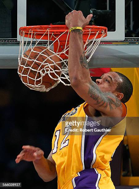 Lakers guard Shannon Brown slams home an alley oop dunk in the first half against the Utah Jazz at Staples Center .