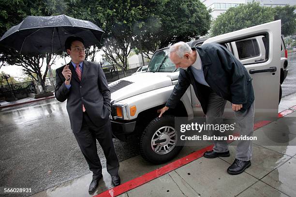 LA Times Columnist, Steve Lopez, checks the tires of LA City Deputy News  Photo - Getty Images