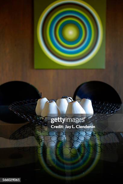 Painting found on Ebay is reflected on the dining room table, with a bowl of white pears received as a gift. Cindy Epping, who renovated her 1960s,...