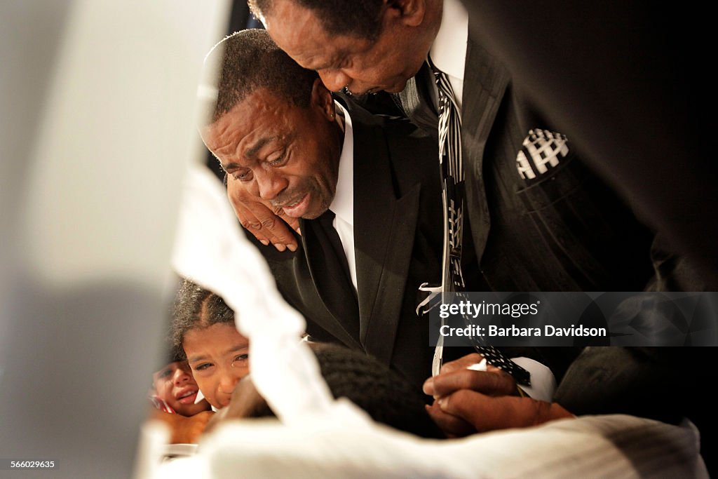 June 26, 09. At New Journey Ministries Church, in Hawthorne, Edward J. Cobbin (center) is comforted