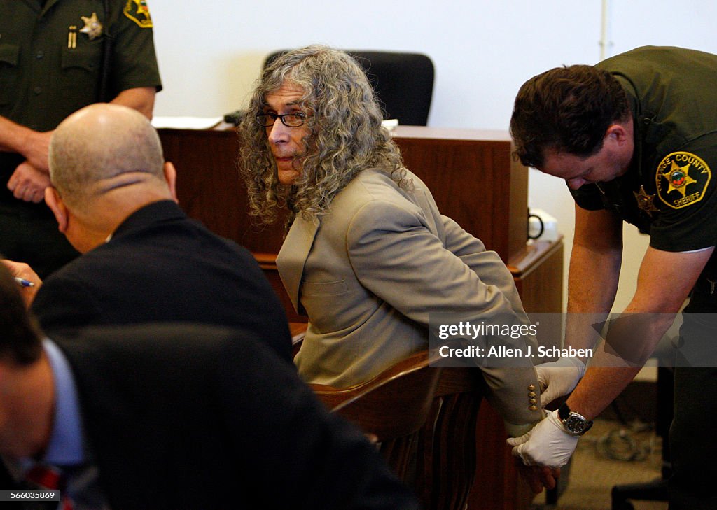 Convicted serial killer Rodney James Alcala confers with his investigator, Alfredo Rasch, while get