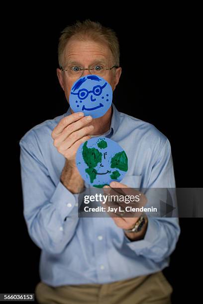 Environmentalist and actor Ed Begley, Jr., is photographed in his Studio City home office holding a reusable shopping bag and two pieces of art, a...