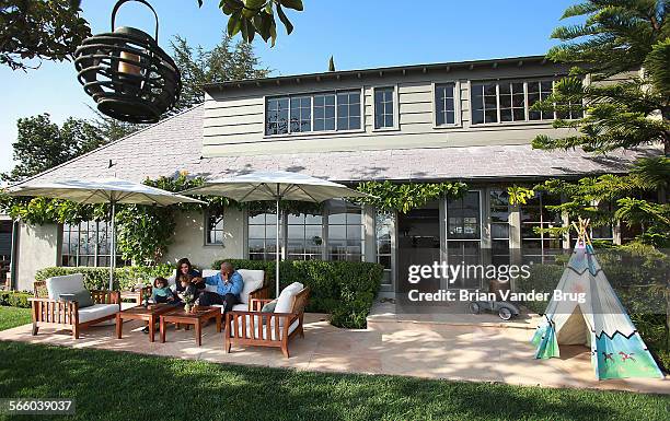 Claire Stansfield with husband Johathan Speaks, right, and children Lucky left, and Rocco in the backyard of their recently remodeled Hollywood Hills...