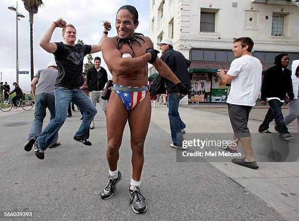 Bodybuilder Amir Edwards performs out on the boardwalk in Venice Beach, with a 10 pound steel ball, wearing just a pair of speedos on December 13,...