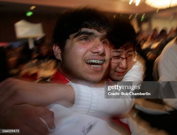 Kevin Gupta, 15 and Albert Lee left to right, embrace after their West High School team from Torrance won the 27th Annual Los Angeles County Academic...