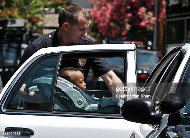 June 25, 2011 ; A child recovered from a barricade situation is being placed in a police car. According to Lt. Andy Neiman of LAPD, police responded...