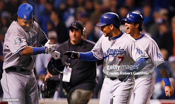 Dodgers teammates Manny Ramirez, left, and James Loney celebrate a fourth inning grand slam by Loney to put LA ahead of the Chicago Cubs 42 in game...