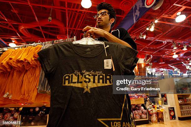 Phillip Magallon prepares to put NBA AllStar tshirts on a rack at the TEAM LA store at Staples Center on February 9, 2011. The AllStar game is...