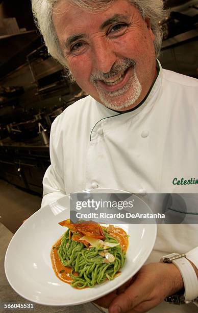 Chef Celestino Drago displaying a plate of Gli Spaghetti Alla Chitarra Con Pesto Alla Trapanese at Drago Centro, downtown L.A. At City National...