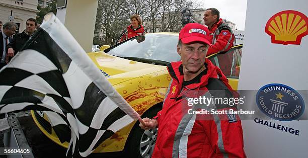 Explorer Sir Ranulph Fiennes waves a starters flag as John Taylor and his wife Helen prepare to depart on their trip around the world on January 17,...