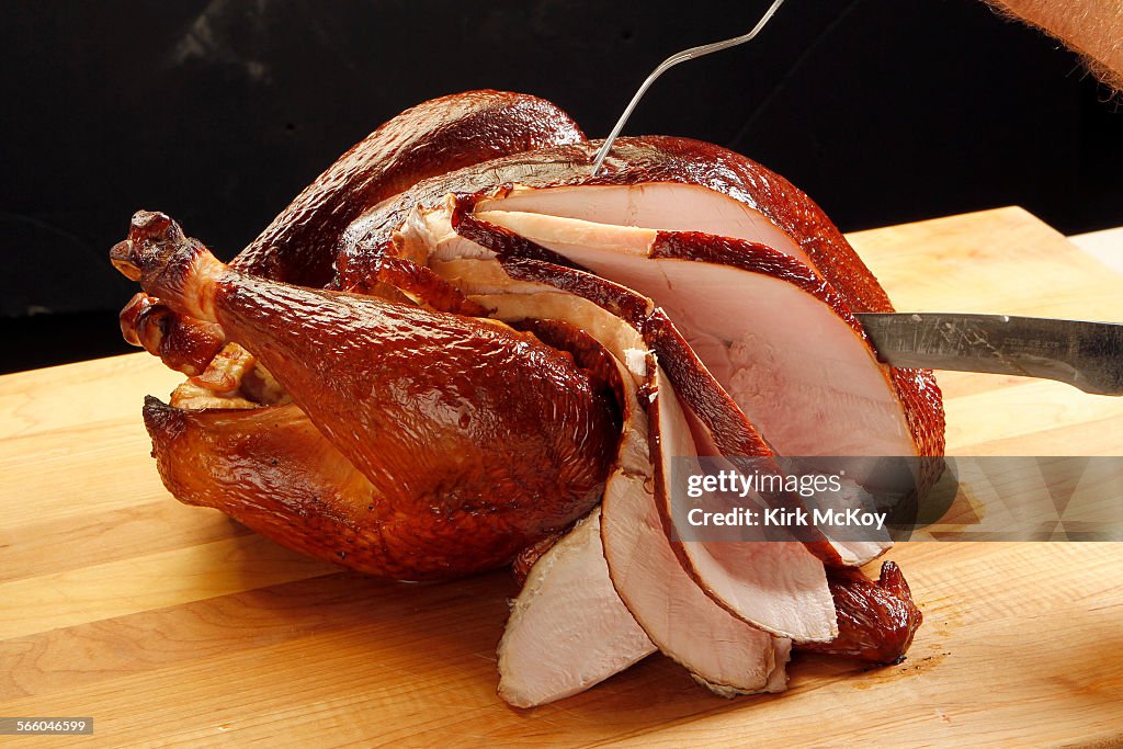 HICKORY SMOKED TURKEY FOR THANKSGIVING BEING SLICED.
