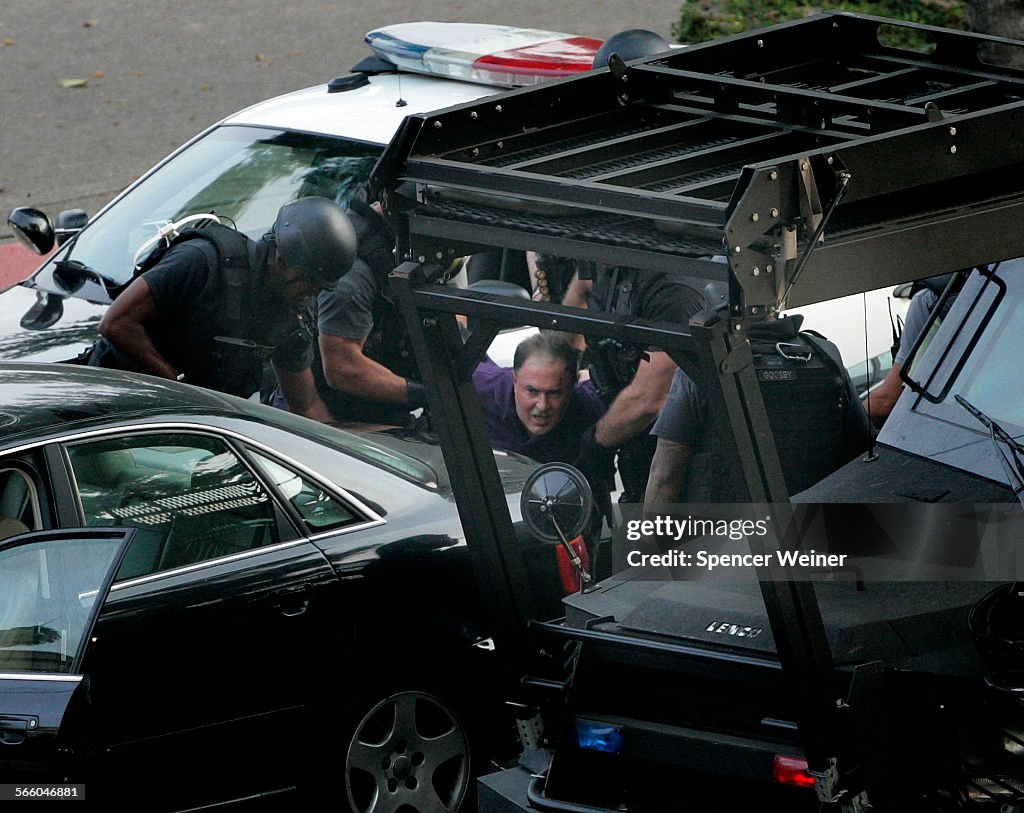 SWAT team drag a man out f his car after shooting him a taser and shooting several tear gas caniste