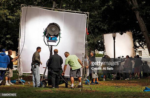 Film crew sets up lights and cameras for shooting the second episode and finishing the pilot for the television series "Franklin & Bash" on the lawn...