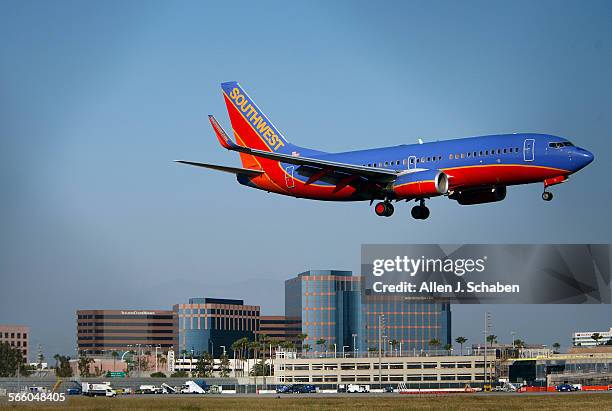 Southwest airplane approaches John Wayne Airport as the Irvine Concourse office buildings are visible in background. The Irvine Concourse is a...