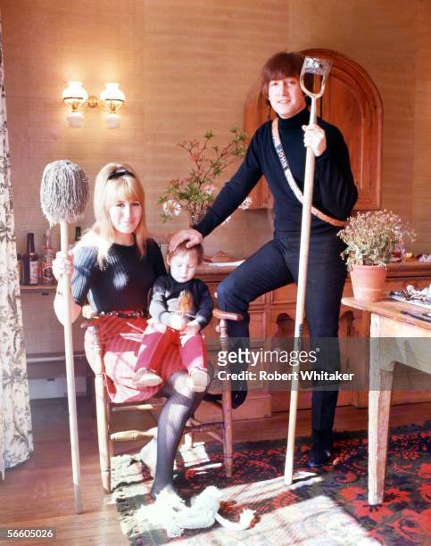 Beatles singer, songwriter and guitarist John Lennon at home with his first wife Cynthia, and their son Julian, at their home at Kenwood, Weybridge,...