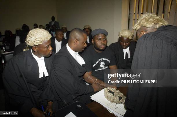 The leader of the Niger Delta People's Volunteer Force, Mujahid Asari Dokubo , talks with his lawyers, led by civil-rights activist Festus Keyamo ,...