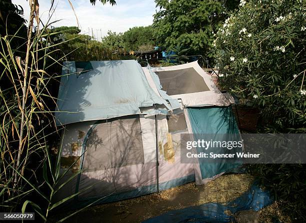 One of several tents and shacks that fill the backyard of Phillip Garrido's property in Antioch, visible over a tall fence and thick brush from a...