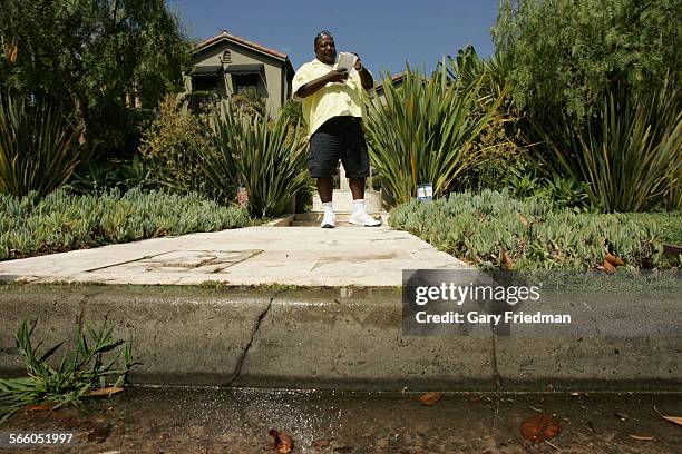 Kevin Cato writes a water violation on Lucerne in the Hancock Park area of Los Angeles on August 7, 2009. Cato is a commercial field representative...