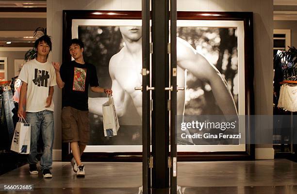 Shoppers leave the Abercrombie & Fitch Co. Store in South Coast Plaza. The store has posted a 28 percent decrease in sales, while overall retail...