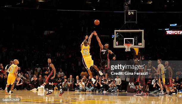 Lakers Kobe Bryant scores the winning shot over Miami Heat Dwyane Wade with 0.4 seconds left on the clock to win 108107 at Staples Center.