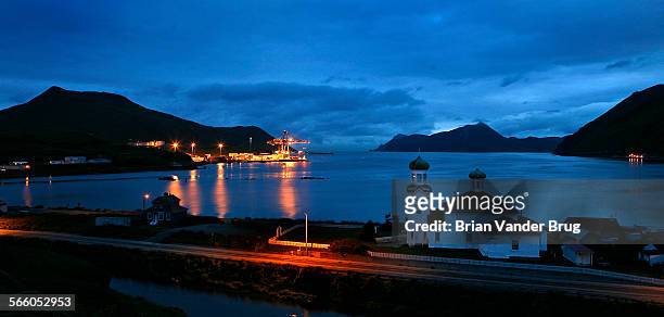 The twin domes of the Russian Orthodox Church in an early morning view from Unalaska on Unalaska Island toward Dutch Harbor. Dutch Harbor is at the...