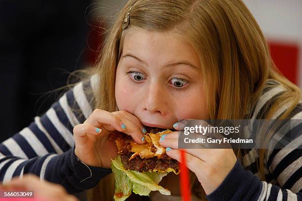 Natalie Meacham enjoys a burger at Five Guys Burgers and Fries, located in Valencia, on March 16, 2011.